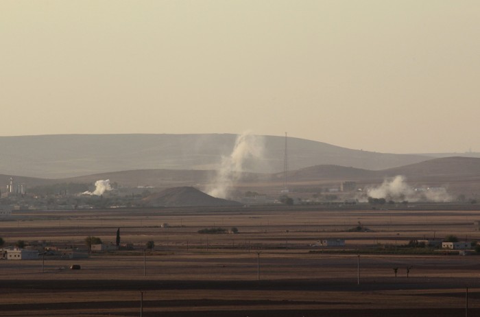 Smoke rises from the Syrian town of Kobani during what activists said were clashes between Islamic State fighters and Kurdish fighters, as seen from a hill in Tal-Hajeb village that overlooks the town