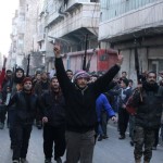 Civilians and Free Syrian Army fighters march during a protest against fighters from the ISIL in the Kadi Askar neighbourhood of Aleppo