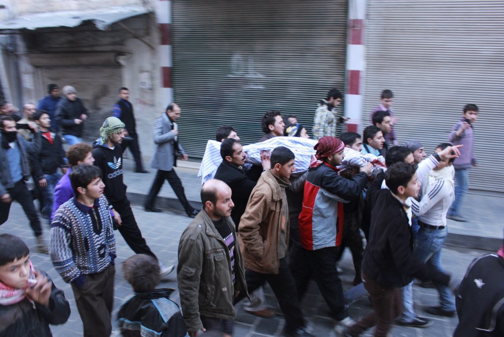 Men carry the body of a Free Syrian Army fighter in Aleppo