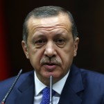 Turkey's PM Erdogan addresses members of parliament from his ruling AK Party during a meeting at the Turkish parliament in Ankara