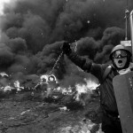 A pro-European protester swings a metal chain during clashes with riot policemen in Kiev