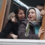 Elvan's sister reacts as his coffin approaches the Okmeydani cemevi, an Alevi place of worship, in Istanbul