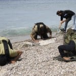Rebel fighters pray at the beach of al-Samra in Latakia province near the town of Kasab