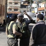 Rebel fighters talk to each other in the Armenian Christian town of Kasab