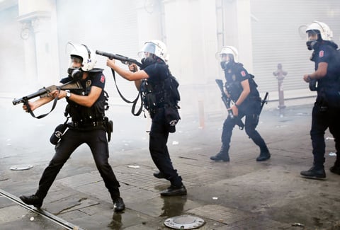 Riot police use tear gas to disperse the crowd during an anti-government protests at Taksim Square in central Istanbul
