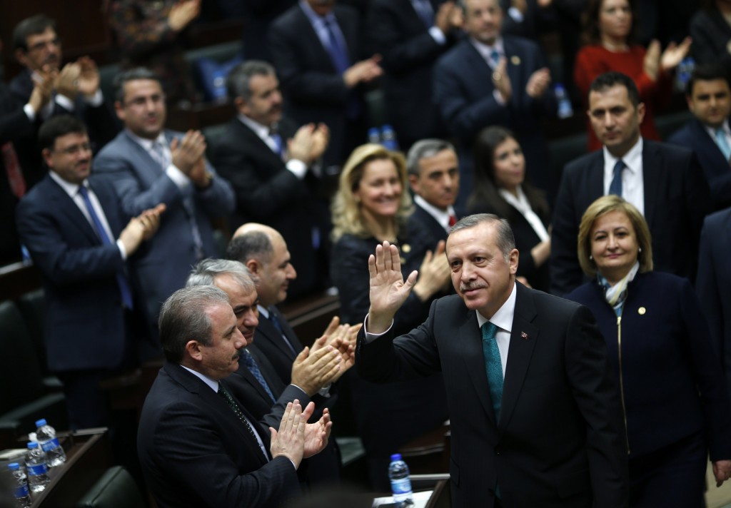 Turkey's Prime Minister Erdogan greets his supporters as he arrives for a meeting at the parliament in Ankara