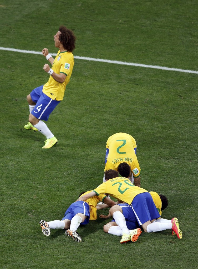 Brazil's players celebrate Oscar's goal during their 2014 World Cup opening match against Croatia at the Corinthians arena in Sao Paulo