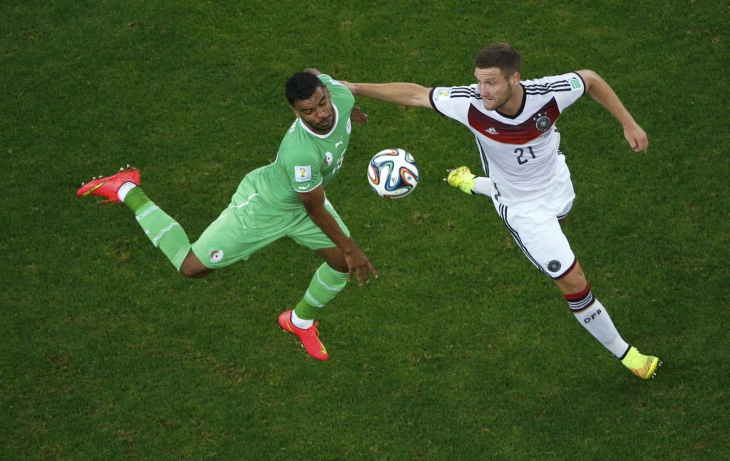 Algeria's Soudani fights for the ball with Germany's Mustafi during their 2014 World Cup round of 16 game in Porto Alegre