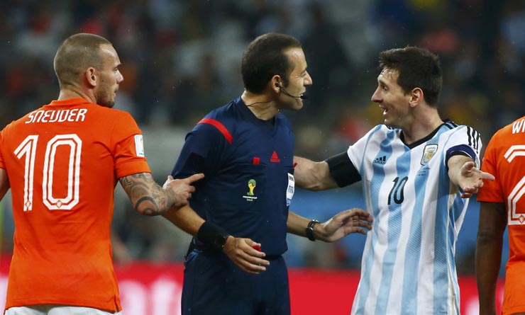 Sneijder of the Netherlands and Argentina's Messi argue with referee Cakir during their 2014 World Cup semi-finals in Sao Paulo