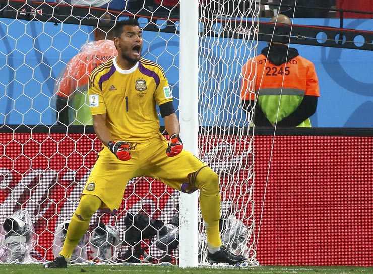 Argentina's goalkeeper Romero celebrates after saving a penalty kick by Vlaar of the Netherlands during the penalty shootout in their 2014 World Cup semi-finals at the Corinthians arena in Sao Paulo
