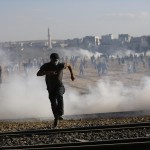 Turkish security forces use tear gas to disperse Turkish Kurds near the Mursitpinar border crossing near town of Suruc