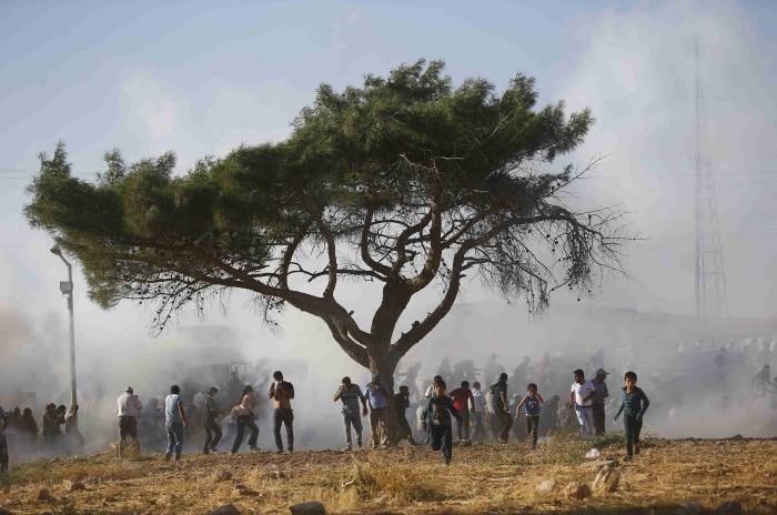 Turkish security forces use tear gas to disperse Turkish Kurds near the Mursitpinar border crossing near town of Suruc