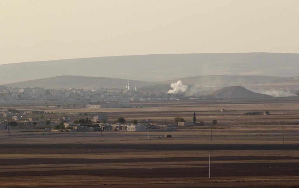 Smoke rises from the Syrian town of Kobani during what activists said were clashes between Islamic State fighters and Kurdish fighters, as seen from a hill in Tal-Hajeb village that overlooks the town
