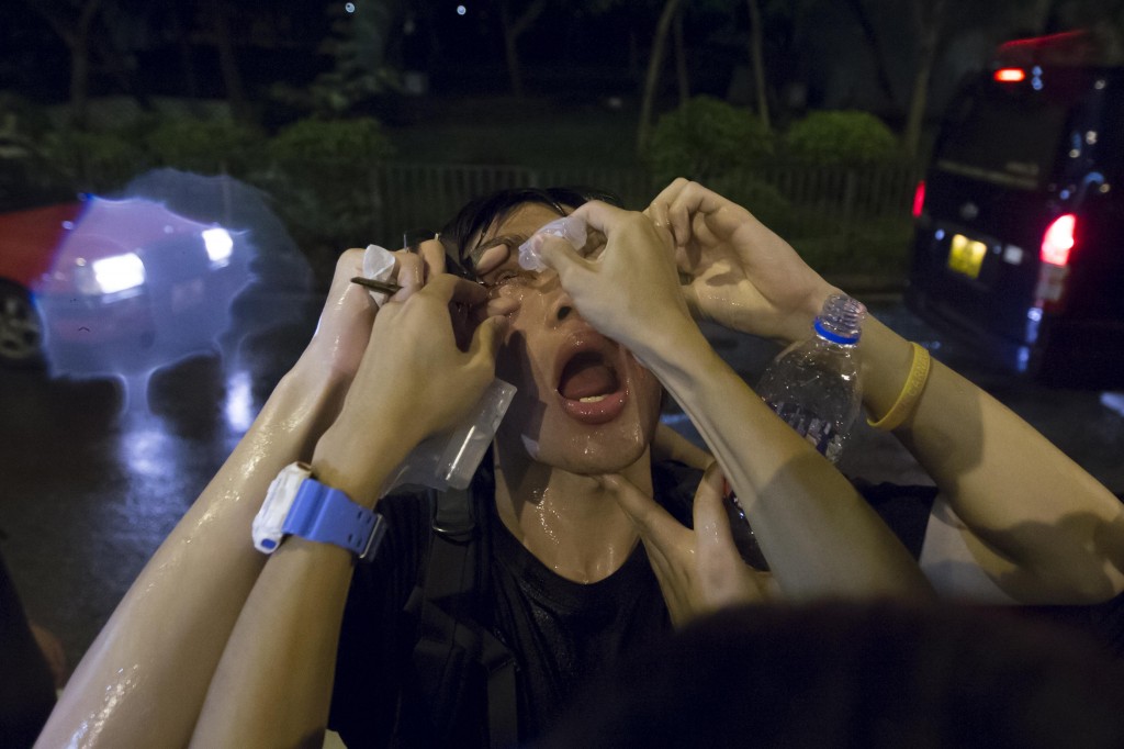 Protester has his eyes washed after police used pepper spray after a confrontation, at Hong Kong's Mongkok district