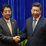 China's President Xi Jinping shakes hands with Japan's Prime Minister Shinzo Abe during their meeting on the sidelines of the APEC meetings in Beijing