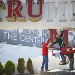 Williams, of Calvi Electric, lowers the M letter from the signage of Trump Plaza Casino to his co-workers in Atlantic City, New Jersey