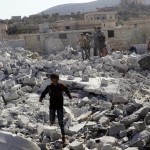 Residents inspect damaged buildings in what activists say was a U.S. strike, in Kfredrian