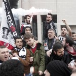 Protesters, who are supporting soccer fans on trial, shout slogans and light flares outside a court in Istanbul