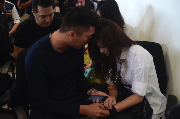Family members of passengers on board AirAsia flight QZ 8501wait for information inside a crisis centre at Juanda Airport in Surabaya, East Java