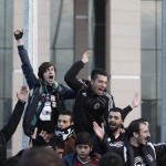 Protesters supporting the soccer fans on trial shout slogans outside a court in Istanbul