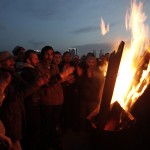 Protesters supporting the soccer fans on trial shout slogans as they keep warm by a fire outside a court in Istanbul