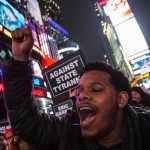Protester, demanding justice for the death of Eric Garner, shouts slogans while marching through Times Square, in the Manhattan borough of New York