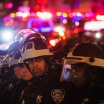 Police stand in formation while creating a roadblock after protesters, demanding justice for the death of Eric Garner, disrupted traffic along the West Side Highway in Manhattan, New York