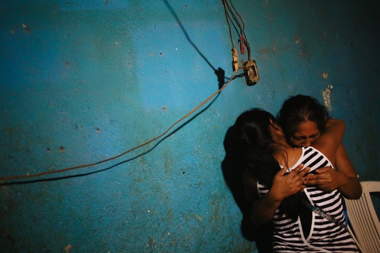 Women embrace in the house of Alexander Mora Venancio, one of the 43 missing students of Ayotzinapa Teacher Training College Raul Isidro Burgo, in El Pericon,