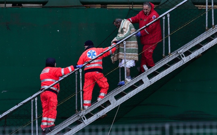 Wounded passenger is helped as he leaves from the " Spirit of Piraeus " cargo container ship at Bari harbour,