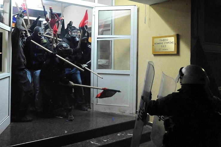 Riot police clash with masked youths occupying the Labour Center of Thessaloniki
