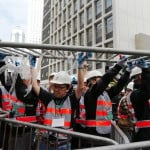 Workers remove barricades at an area blocked by pro-democracy protesters near the government headquarters building at the financial Central district in Hong Kong
