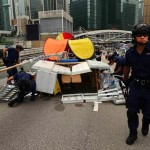Police remove an art installation at an area, previously blocked by pro-democracy protesters, near the government headquarters building at the financial Central district in Hong Kong