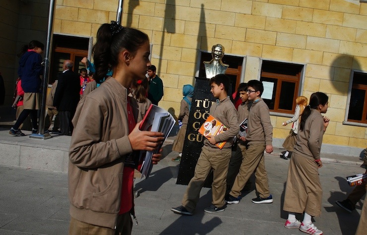 Students of Tevfik Ileri Imam Hatip School walk past a statue of Mustafa Kemal Ataturk, founder of secular Turkey, in Ankara