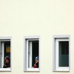 Women look out from windows of the mosque before a memorial service for late student Tugce Albayrak in Waechtersbach