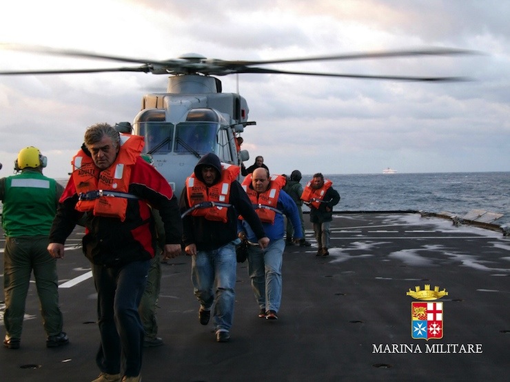 Passengers arrive on the Italian Navy's vessel San Giorgio after the car ferry Norman Atlantic caught fire in waters off Greece