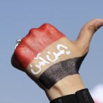 An anti-Houthi protester raises her fist painted with a Yemeni flag during a rally in Sanaa