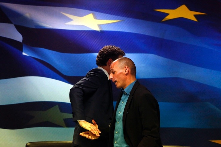 Dijsselbloem, head of the euro zone finance ministers' group, and Greek Finance Minister Varoufakis shake hands after their common press conference at the ministry in Athens