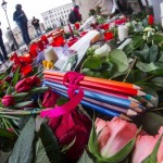 Pencils and flowers of condolance are placed at the French embassy at Pariser Platz in Berlin