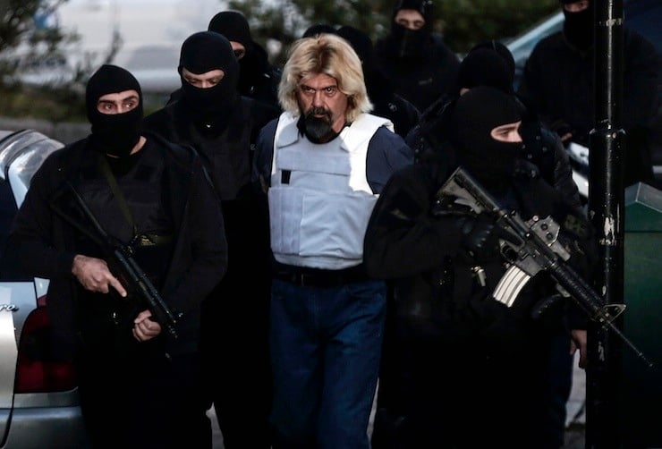 Greek fugitive Christodoulos Xiros is escorted by anti-terrorism police officers to the prosecutor in Athens