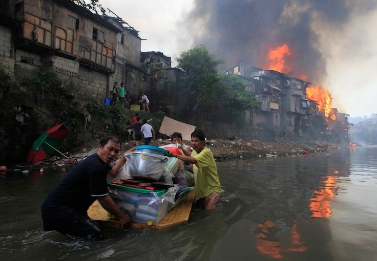 Residents salvage their belongings after a raging fire engulfed around 200 houses in Quezon city, metro Manila
