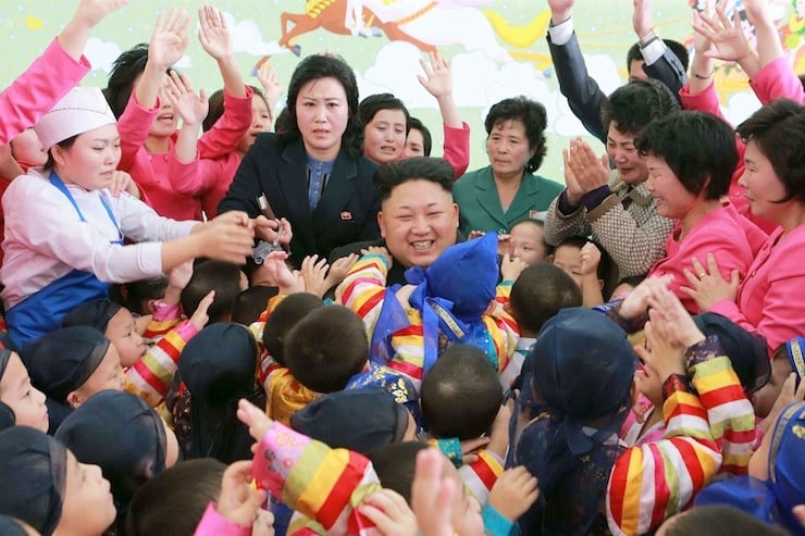North Korean leader Kim Jong Un poses for a picture with children during a visit to the Pyongyang Baby Home and Orphanage on New Year's Day