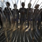 Nepalese riot police personnel stand guard in front of a barricade during a general strike in Kathmandu