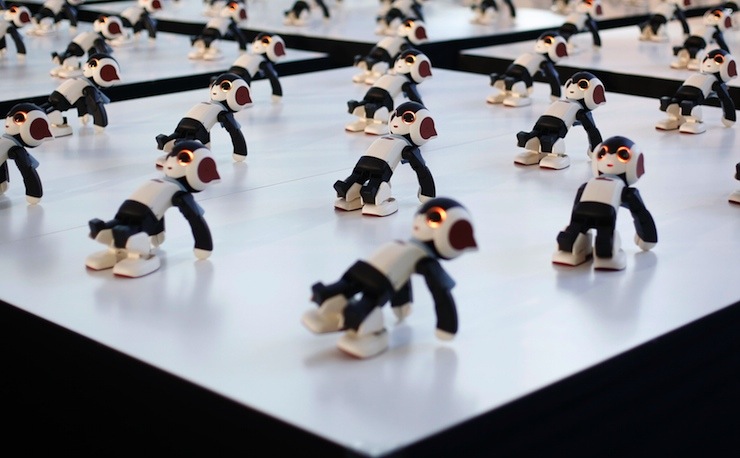 Humanoid communication robots called Robi perform a synchronized dance during a promotional event called 100 Robi, for the Weekly Robi Magazine, in Tokyo