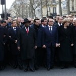 French President Hollande is surrounded by head of states as they attend the solidarity march in the streets of Paris