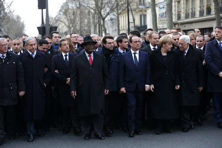 French President Hollande is surrounded by head of states as they attend the solidarity march in the streets of Paris