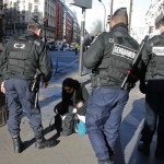 French Gendarmes check a passerby's bag as they secure the access to the solidarity march in the streets of Paris