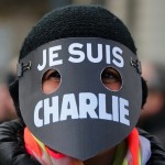 A women wearing a mask reading “I am Charlie” takes part in a solidarity march (Marche Republicaine) in the streets of Paris