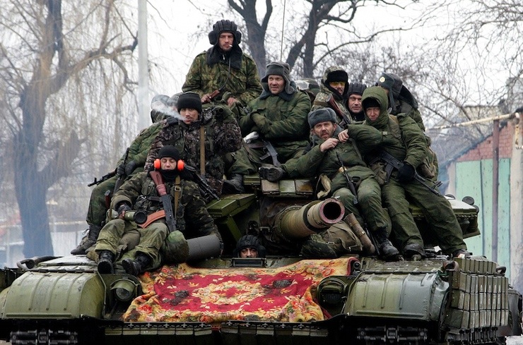 Members of the armed forces of the separatist self-proclaimed Donetsk People's Republic drive a tank on the outskirts of Donetsk