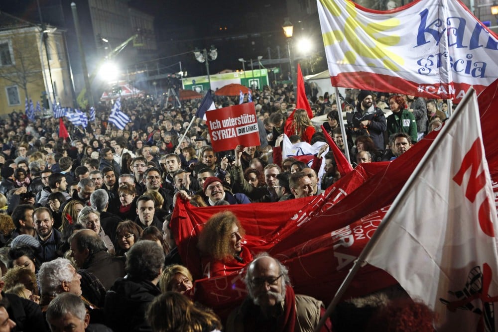 Supporters of radical leftist Syriza party chant slogans and wave Greek national and other flags after winning elections in Athens