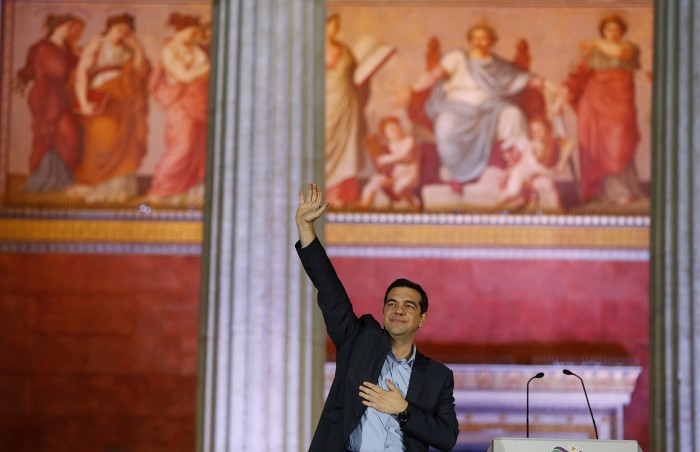 Head of radical leftist Syriza party Tsipras gestures to supporters after winning elections in Athens